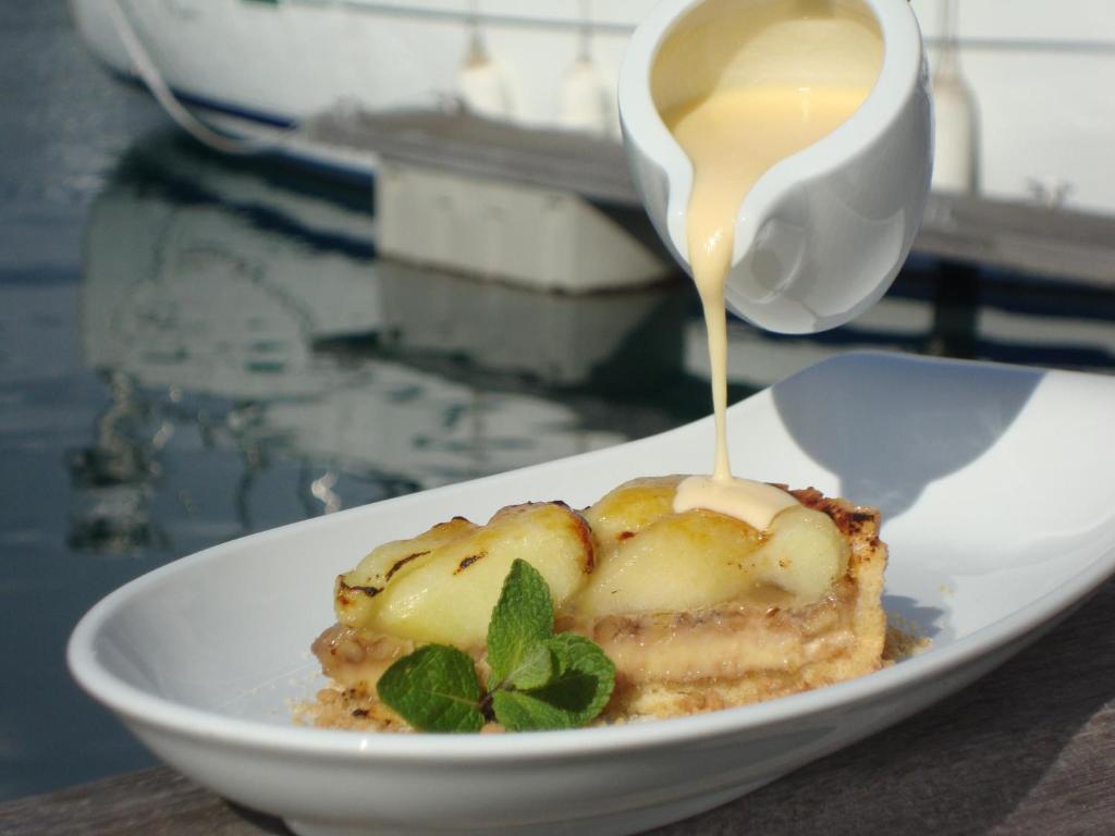 a plate of food with a cup of tea on top at Troia Design Hotel in Troia
