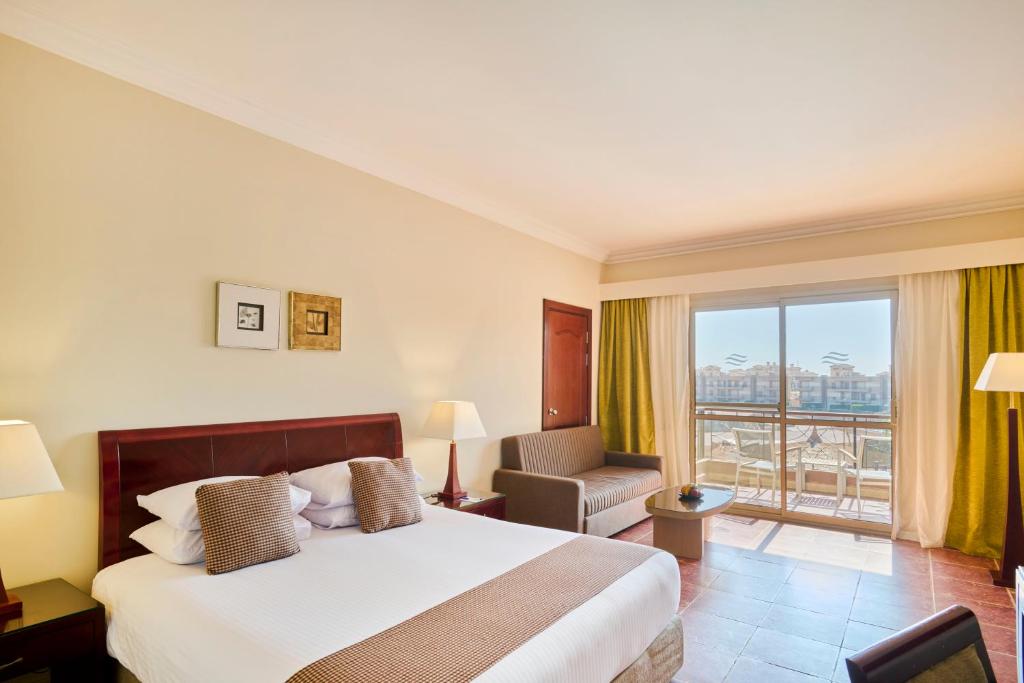 A bed or beds in a room at Coral Sea Beach and Aqua Park