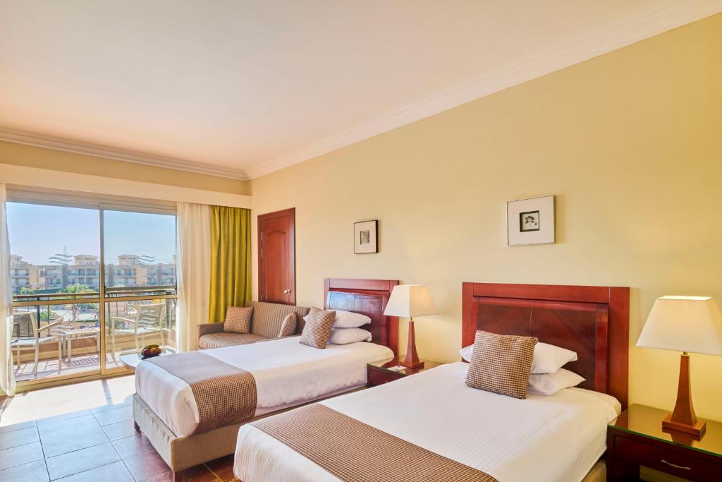 A bed or beds in a room at Coral Sea Beach and Aqua Park