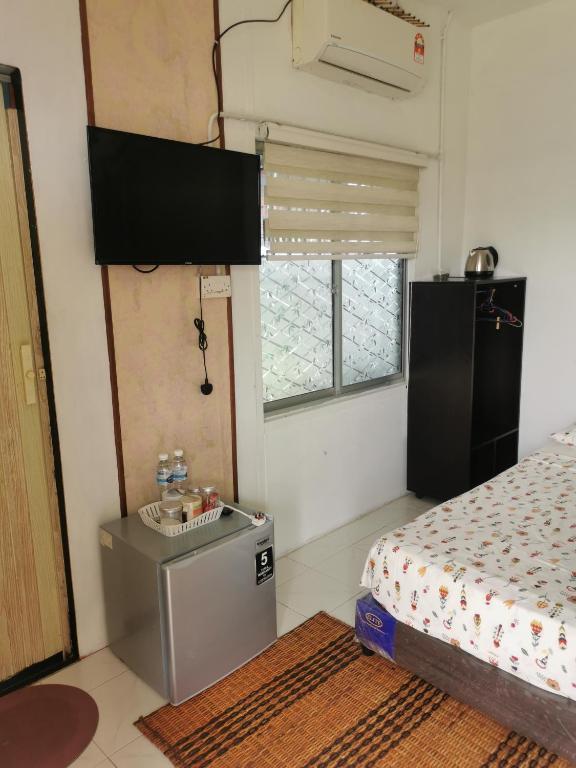 Voodi või voodid majutusasutuse Merdeka Guest House 2 toas