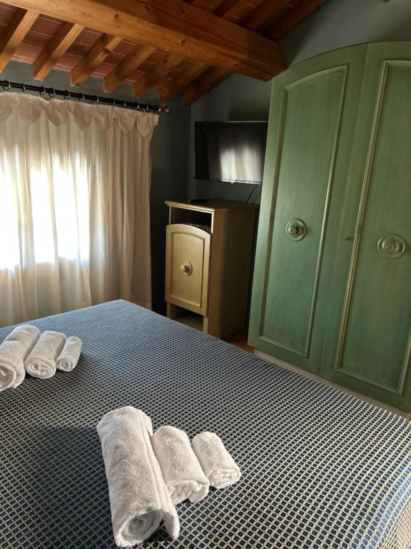a bedroom with towels on a bed with a cabinet at The Tower in Torreglia