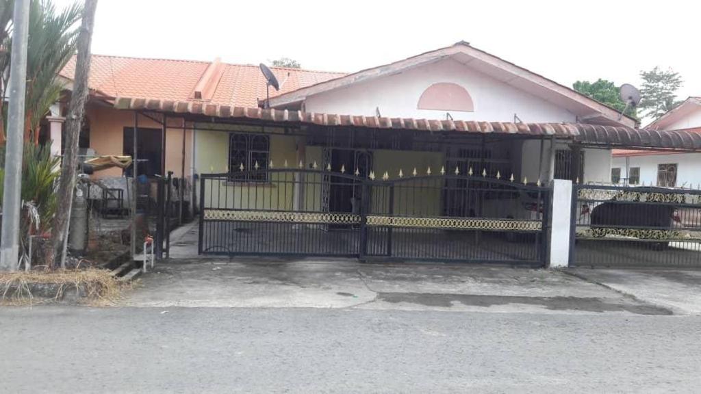 a house with a gate in front of it at Yanzz Homestay in Kampong Sorosob