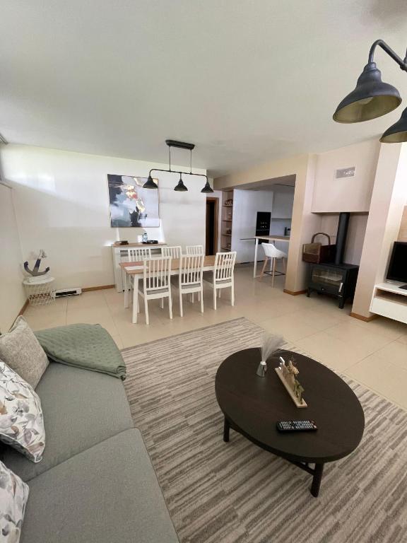 a living room with a couch and a table at Refúgio da praia in Tocha