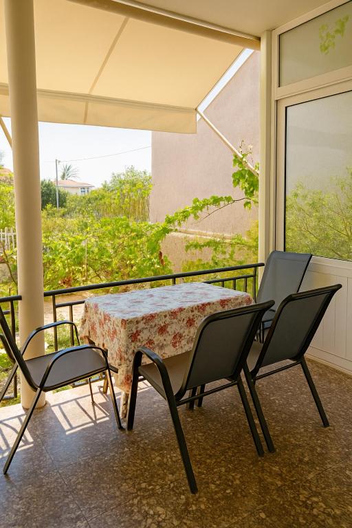 a table and chairs on a balcony with a view at Mia Home in Artemida