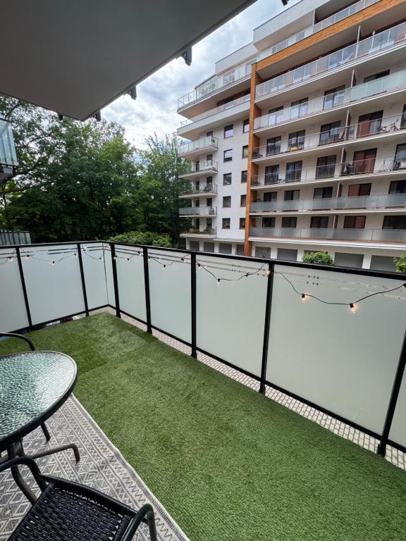 a balcony with a table and chairs and a building at Loftowe Love in Kołobrzeg