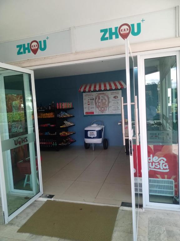 an entrance to a store with a up sign on the door at Carneiros Beach Resort Flat in Tamandaré