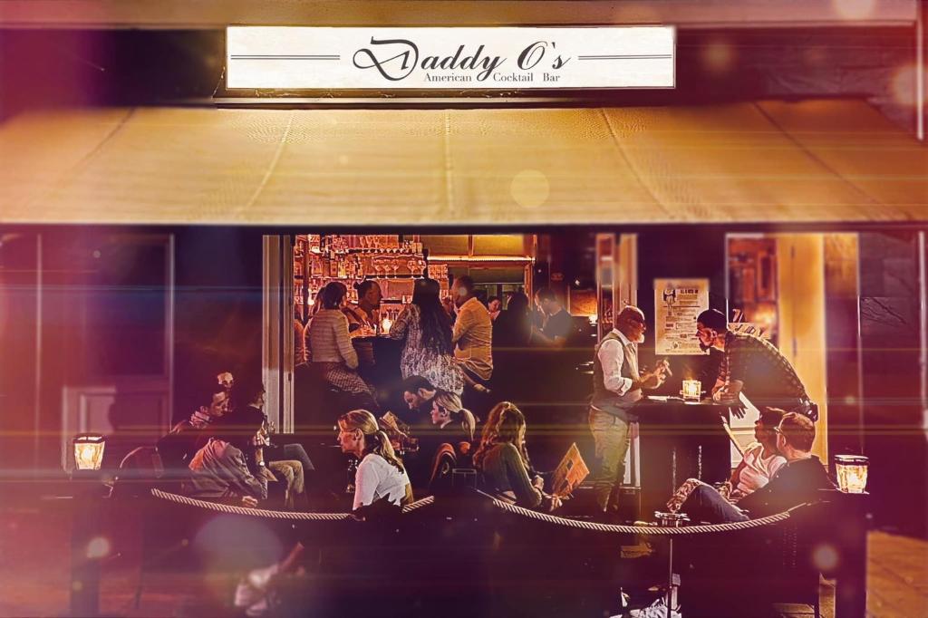 a group of people sitting at a bar at Bar'n'Bed in der schönen Koblenzer Altstadt in Koblenz