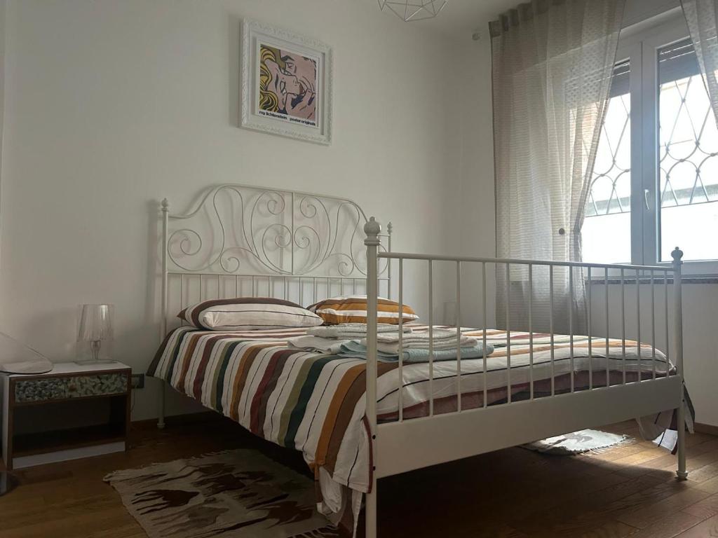 a bedroom with a bed and a window at La casina di Ale in Turin