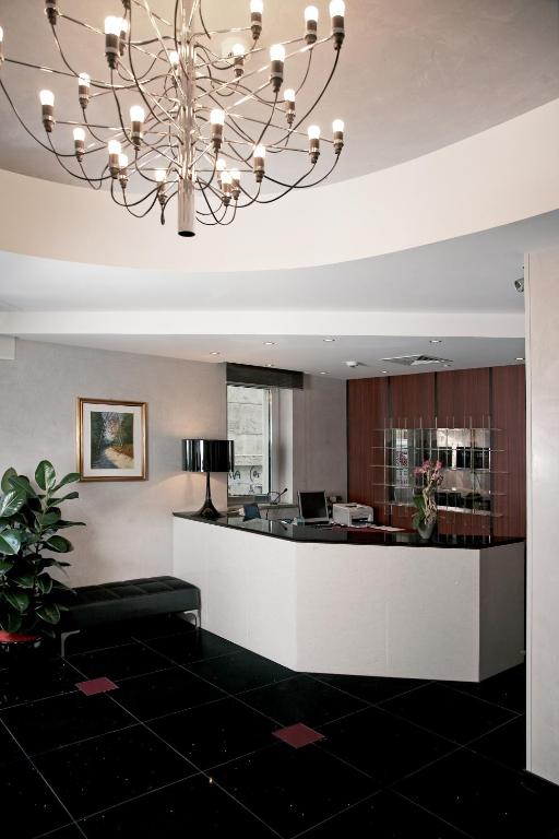 a lobby with a large chandelier in a building at Victoria Hotel in Pescara