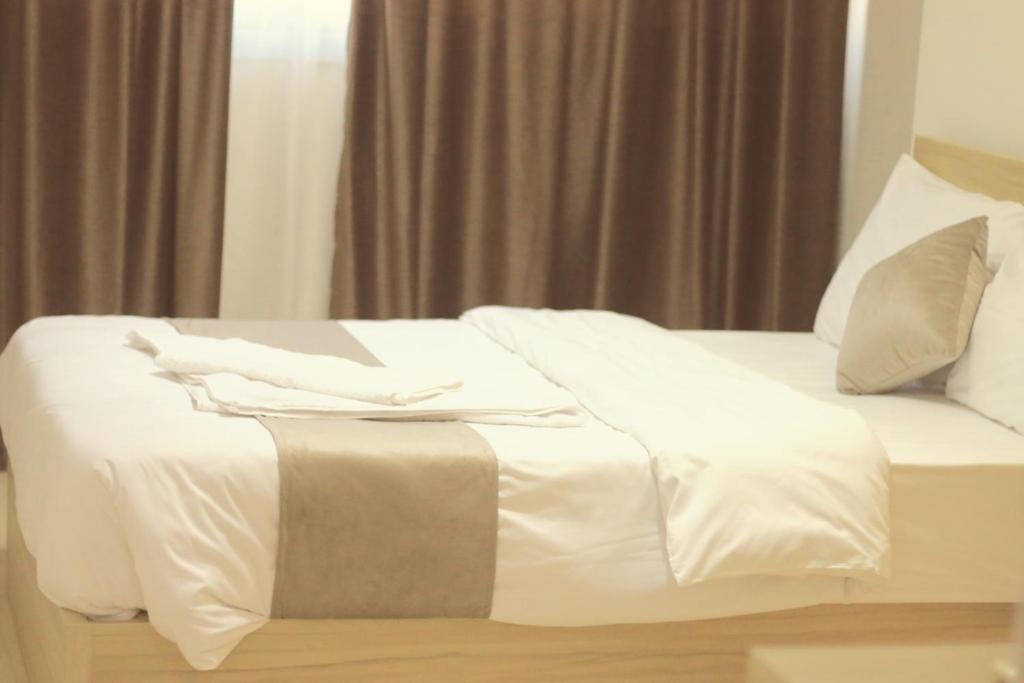 Postel nebo postele na pokoji v ubytování Nile Diamond Suites
