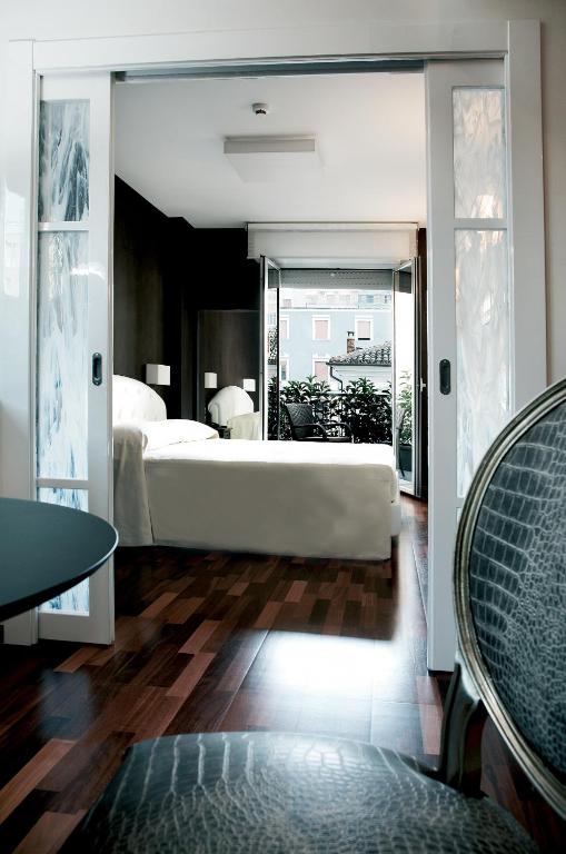 a bedroom with a bed and a large mirror at Victoria Hotel in Pescara