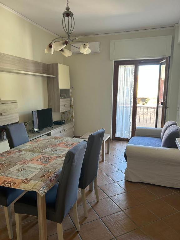 a living room with a table and a couch at Casa Mare Verde in Casamicciola Terme