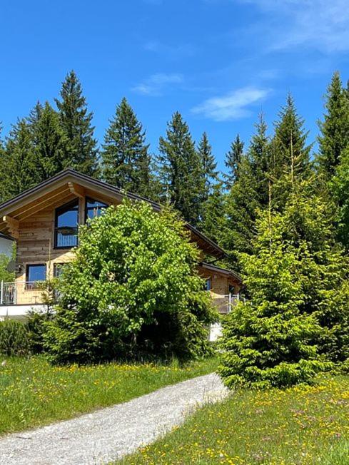 a house on a hill with trees in the background at Chalet Bergheimat in Wagrain