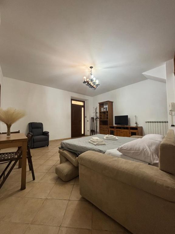 a large bedroom with a bed and a couch at Casa Al Vicolo in Seravezza