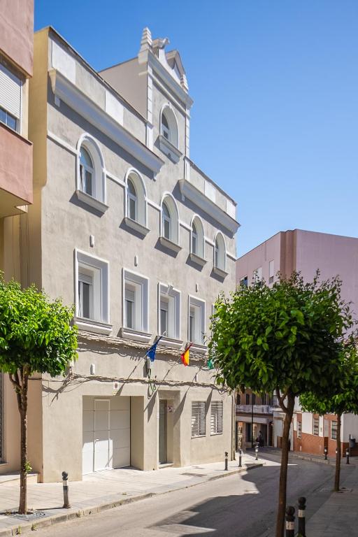 a building on a street with trees in front of it at Apartamento centro ciudad patio cuarenta 2A in Algeciras