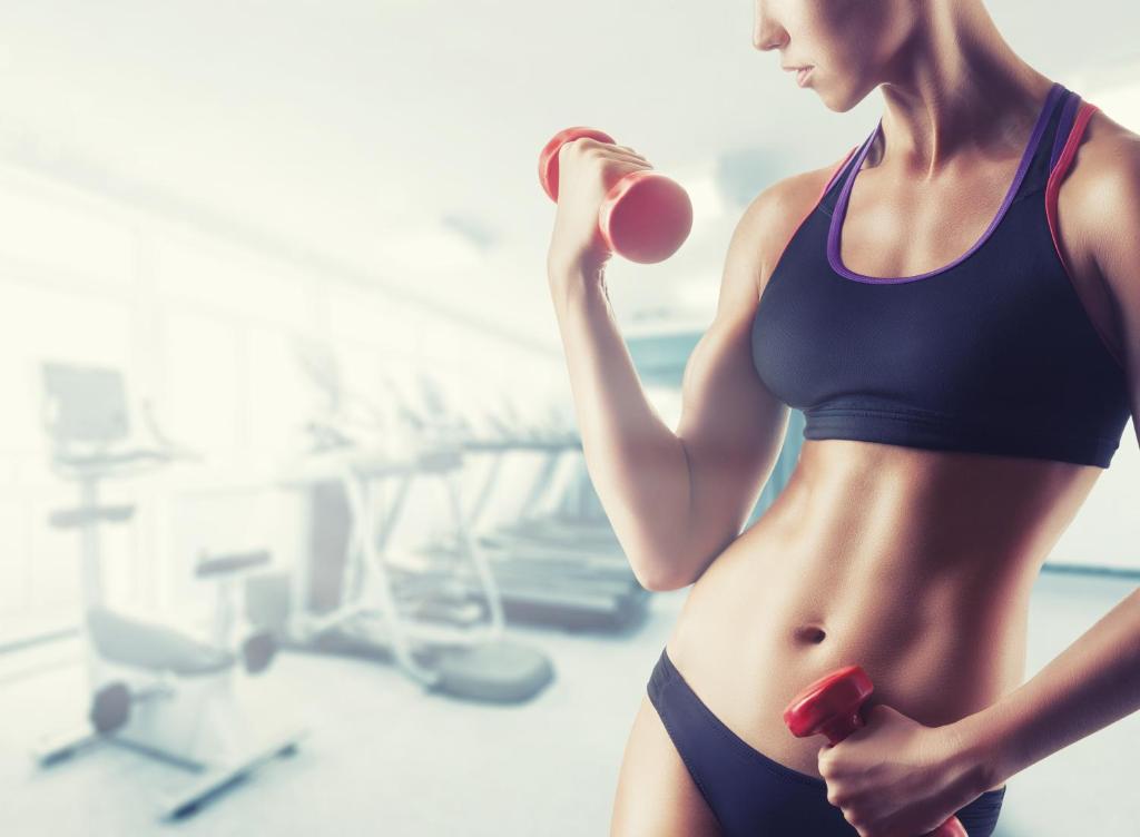 a young woman in a swimsuit holding a dumbbell at Victoria Hotel in Pescara