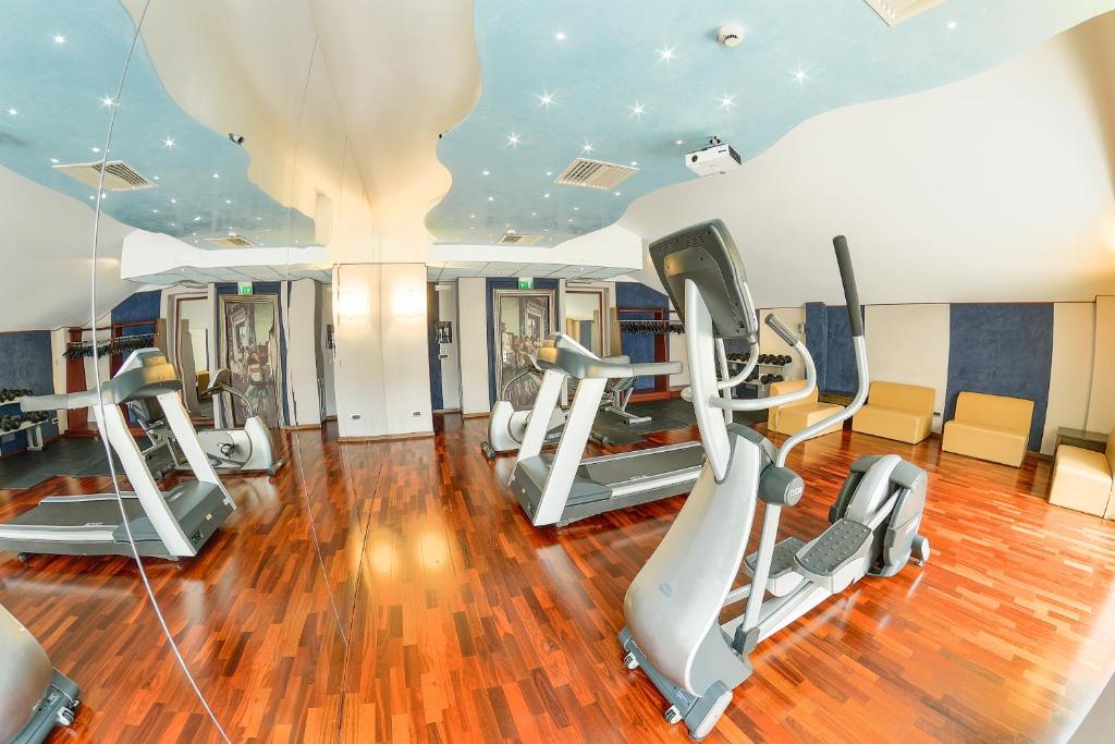 a gym with treadmills and elliptical machines at Victoria Hotel in Pescara