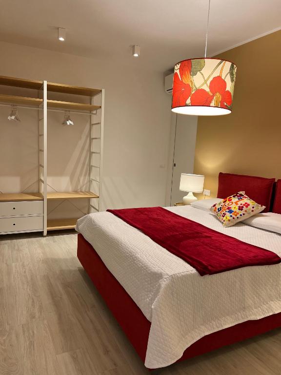 a bedroom with a large bed and a lamp at Appartamento Gocce di sole in Pietra Ligure