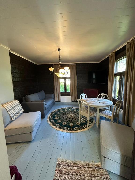 a living room with a couch and a table at Torppari in Kokkola