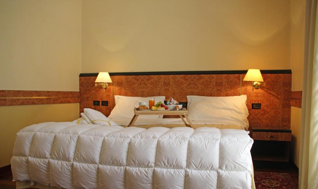Postel nebo postele na pokoji v ubytování Park Hotel Villa Leon d'Oro