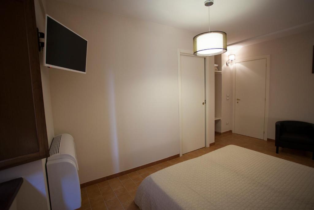 Postel nebo postele na pokoji v ubytování Helios Assisi