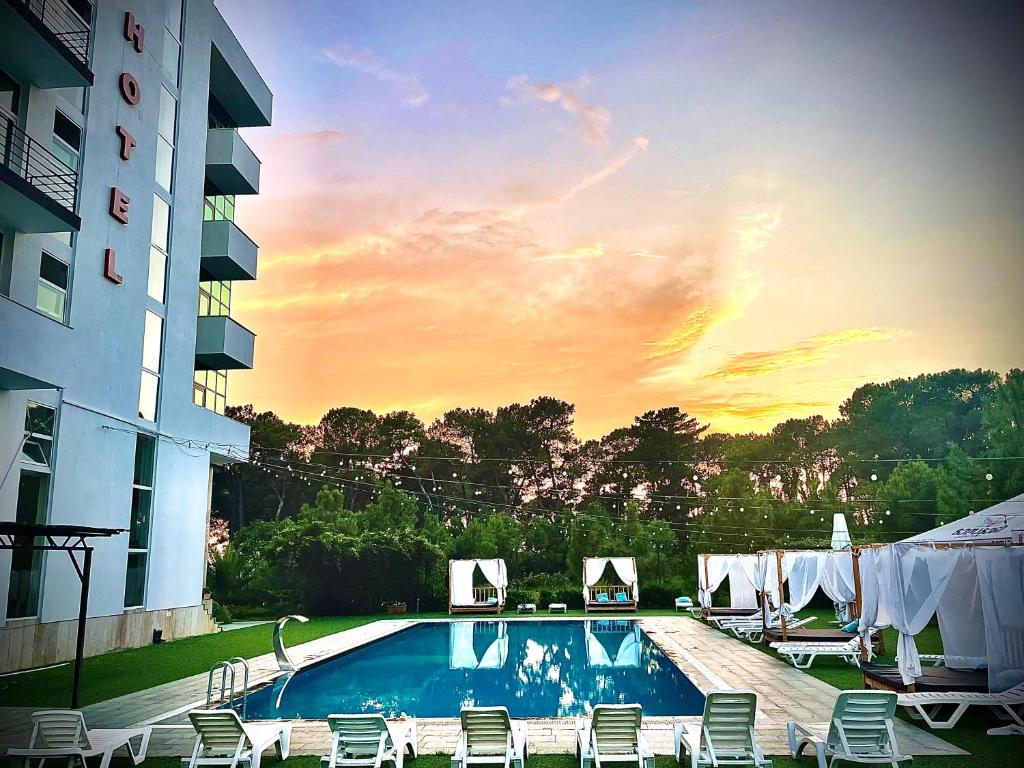 a swimming pool in front of a building at Hotel Aeetes Kobuleti in Kobuleti