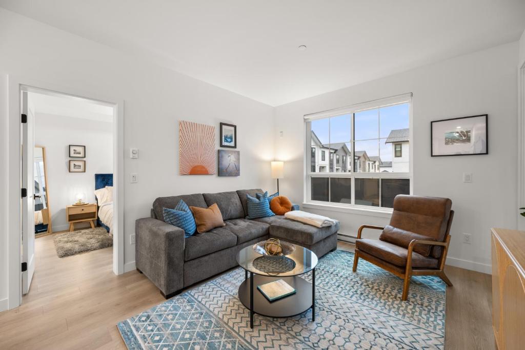 a living room with a couch and a chair at Chic Condo with Stylish Amenities in White Rock in Surrey