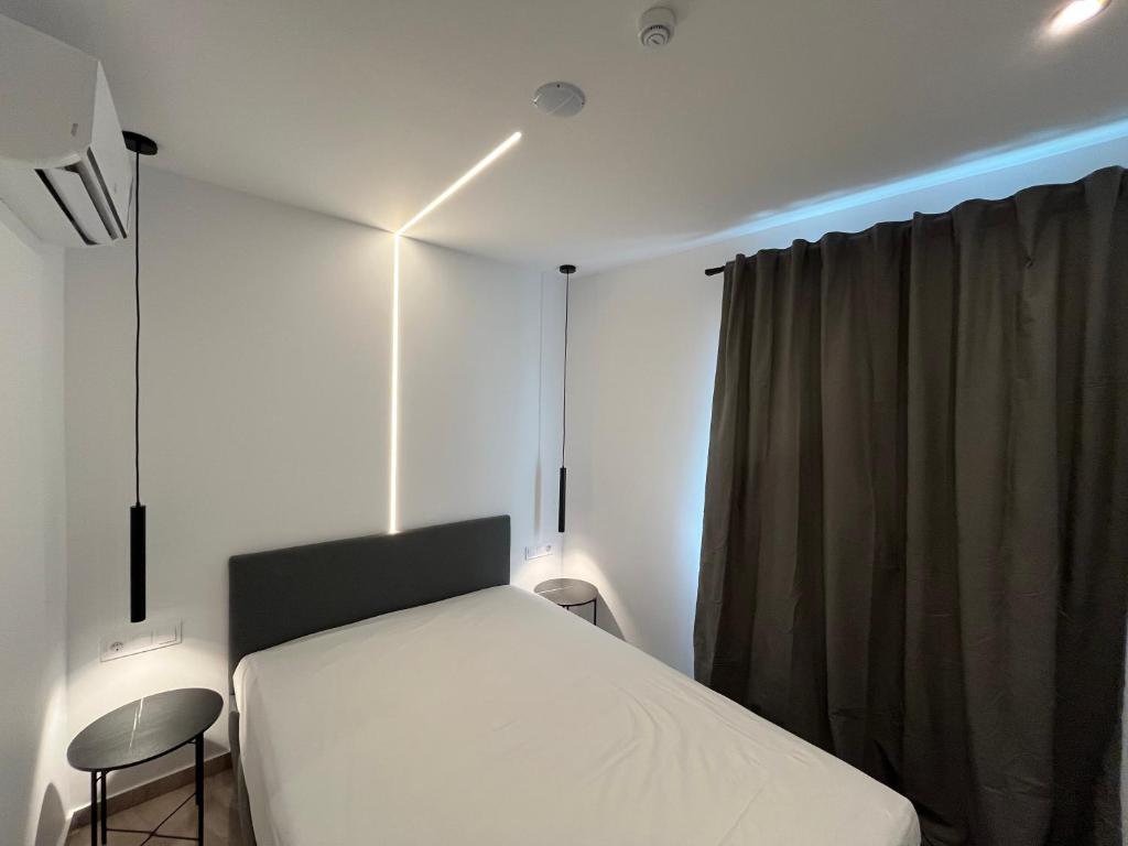 a bedroom with a bed and a chair and a window at Central -III- Room in Athens