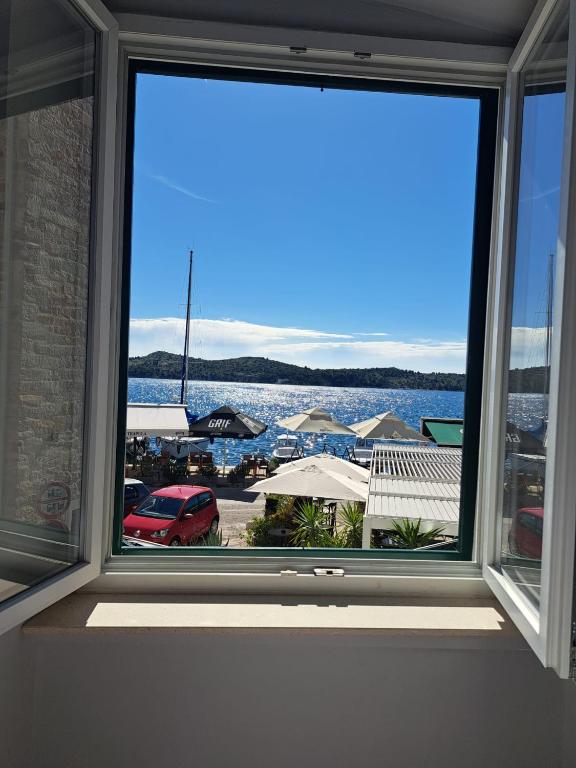 a window in a room with a view of a harbor at La Vie Seaside Residences in Šibenik