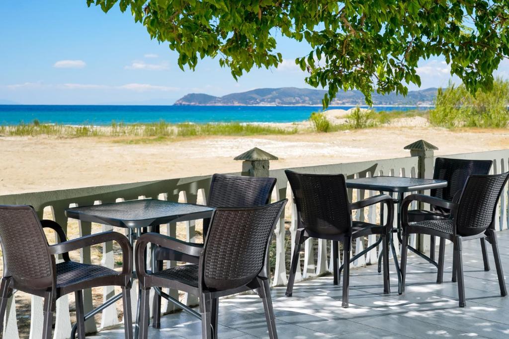 a group of chairs and tables on the beach at Olivento Beach Front Suites in Potos