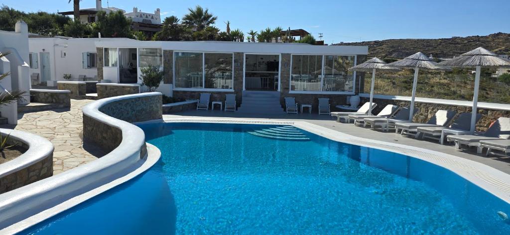 a swimming pool with blue water in a resort at Casa Bianca in Ornos