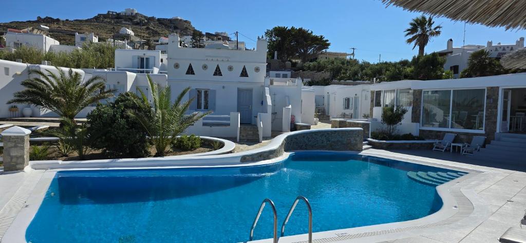 a swimming pool in front of a villa at Casa Bianca in Ornos