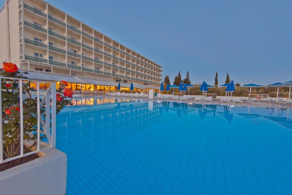 a large swimming pool in front of a hotel at Palmariva Beach Hotel by Anayia All Inclusive Resorts in Eretria