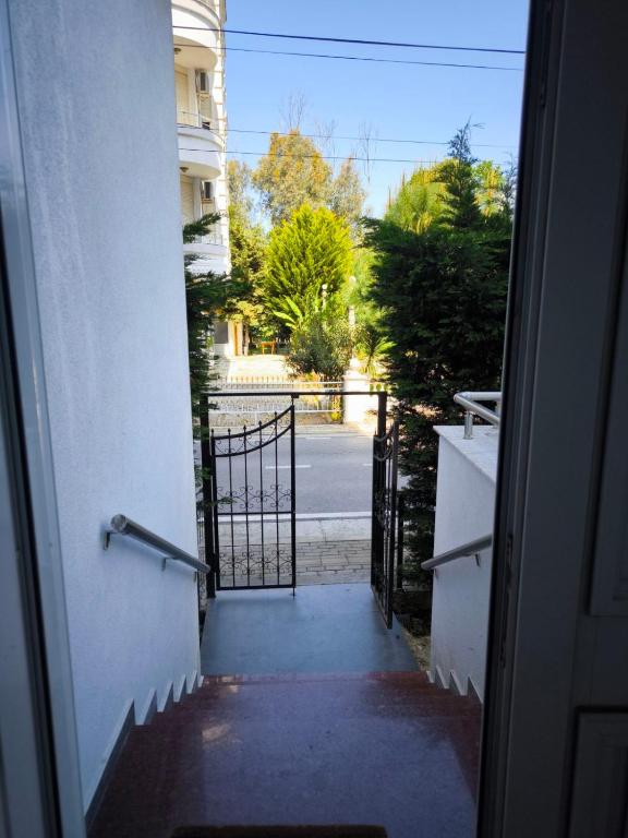 an open door to a gate in a building at All Seasons Apartment in Durrës