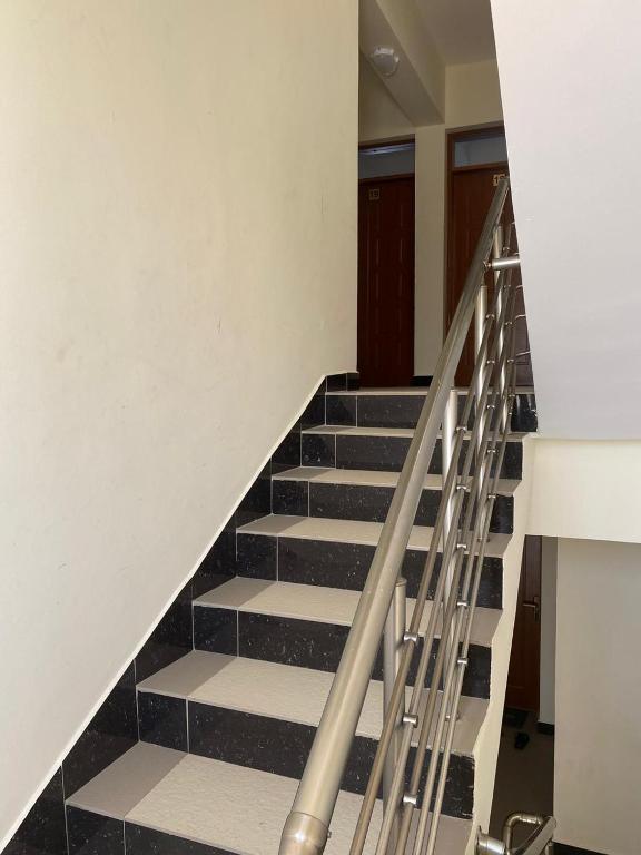 a staircase with black and white tiled floors at The KONGONI PLACE in Gatunga