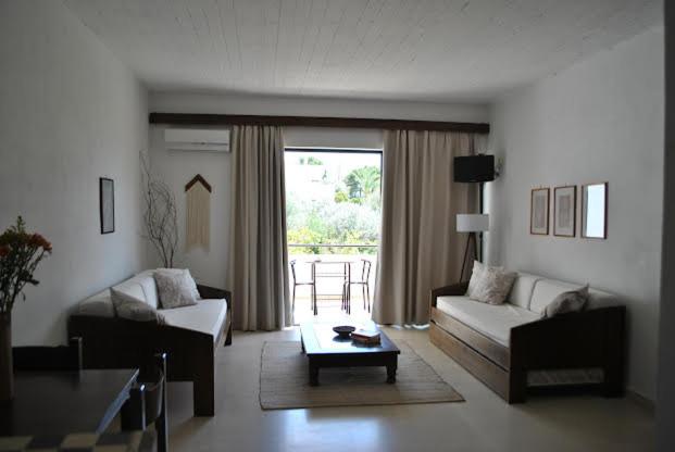 a living room with two couches and a coffee table at Thalassa Studios in Loutrá Kounoupélli