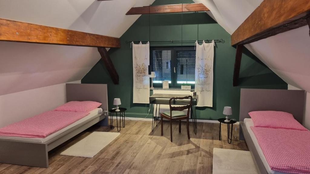 ein Zimmer mit zwei Betten und einem Schreibtisch in der Unterkunft Cottbus Merzdorf Bauernhaus Ferienhaus in Cottbus