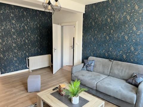 a living room with a couch and a table at L escale in Givet