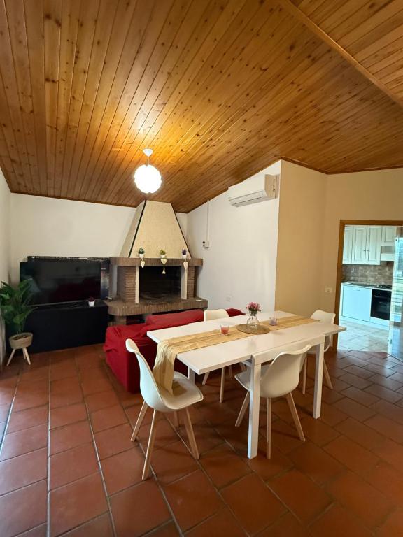 a dining room with a table and a couch at Grande appartamento Stella Marina in Misano Adriatico