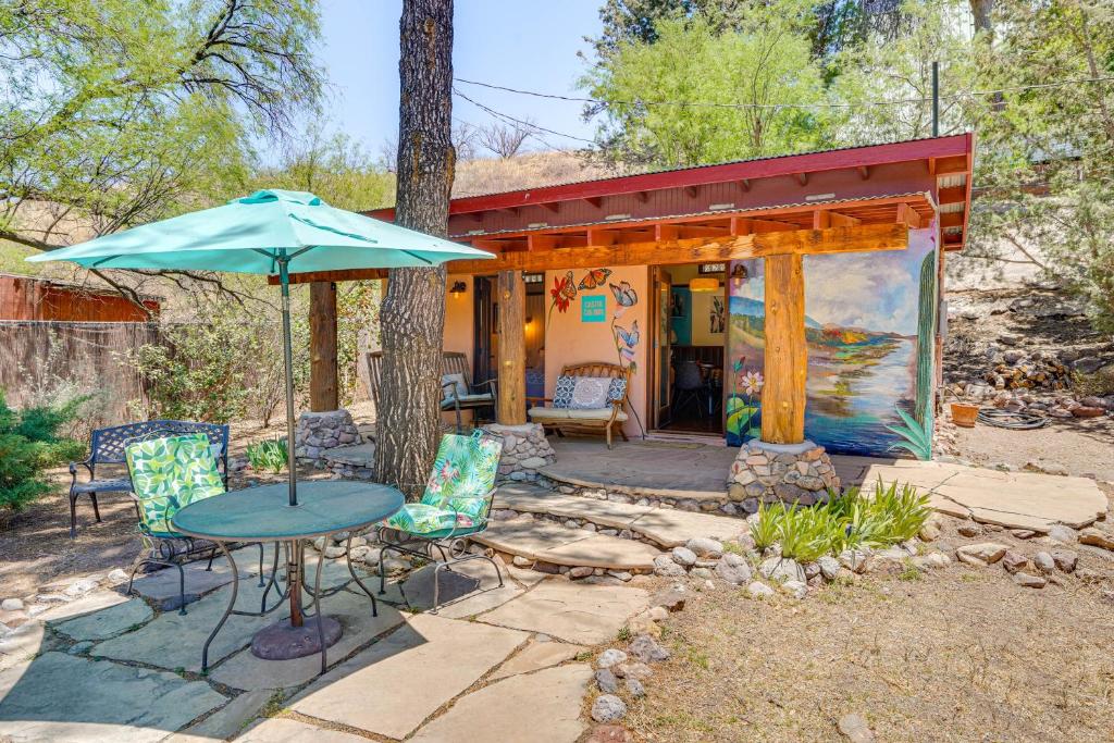 a patio with a table and chairs and an umbrella at Casita Colibri Lovely, Romantic Patagonia Retreat in Patagonia