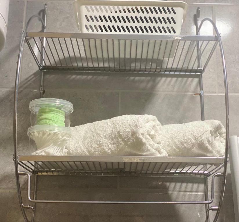 a shelf in a refrigerator with a jar and a towel at City centar lux apartman in Zlatibor