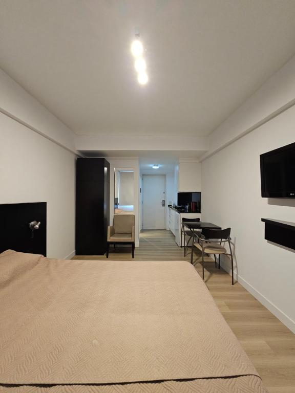 a bedroom with a bed and a couch and a table at Tempora 621 in Buenos Aires