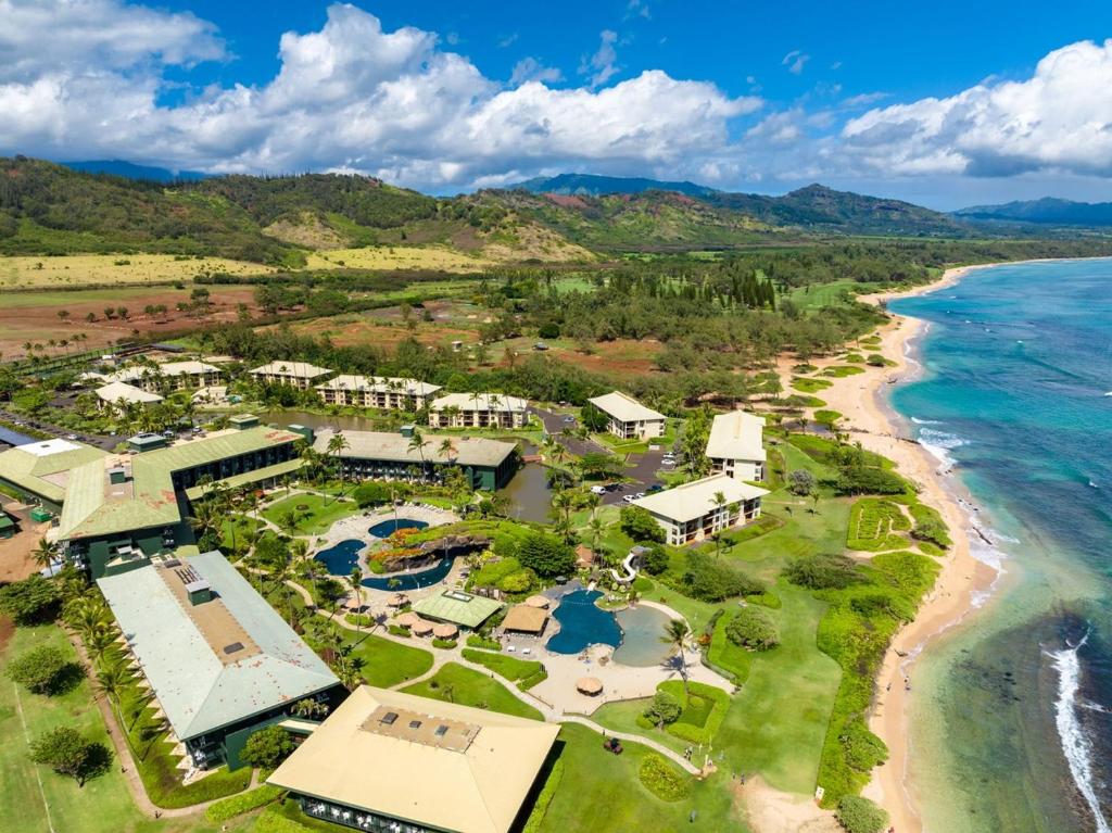 an aerial view of a resort next to the ocean at Pool Oceanview Lanai, Beachfront 4-Star Resort, King Bed, AC, Pool, Restaurant, Gym, Spa in Lihue