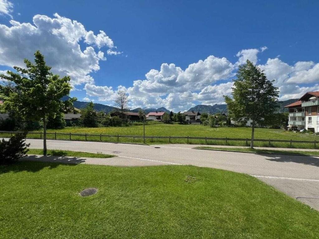 an empty road in a residential neighborhood with trees and houses at 1-bedroom holiday apartment in Oberstdorf