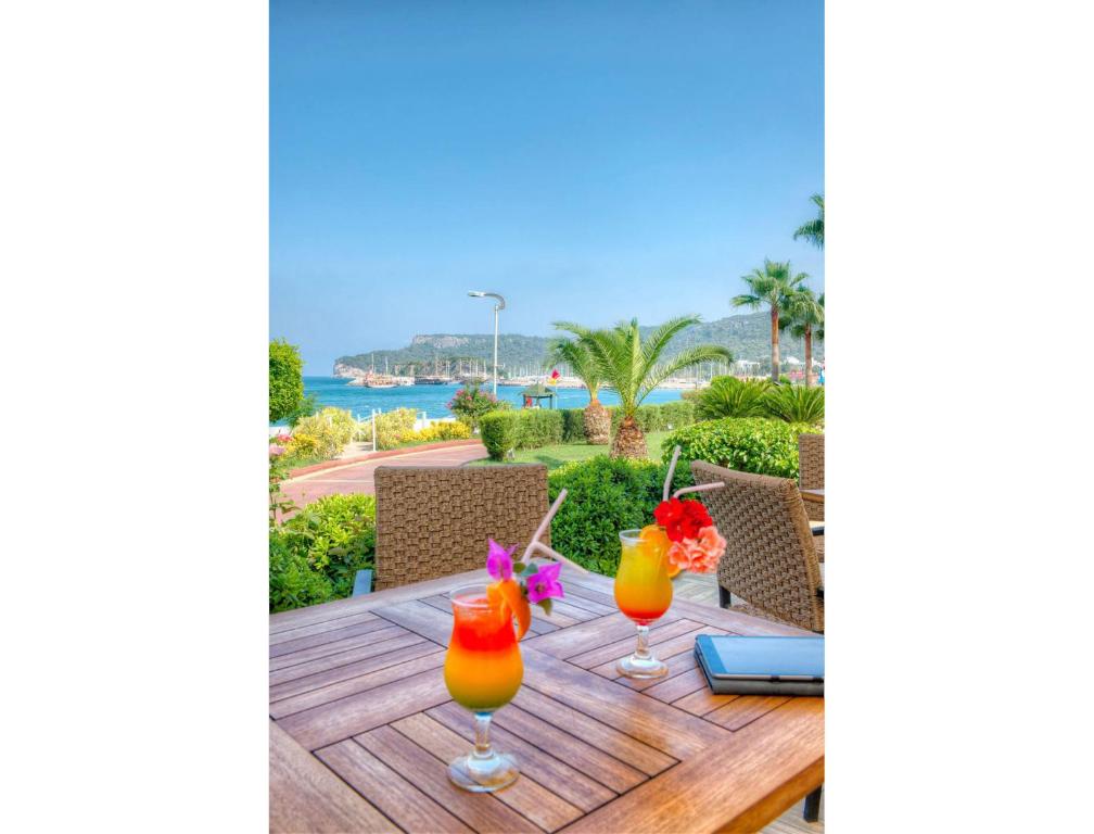 a table with two cocktails on top of a table at Golden Lotus Hotel in Kemer