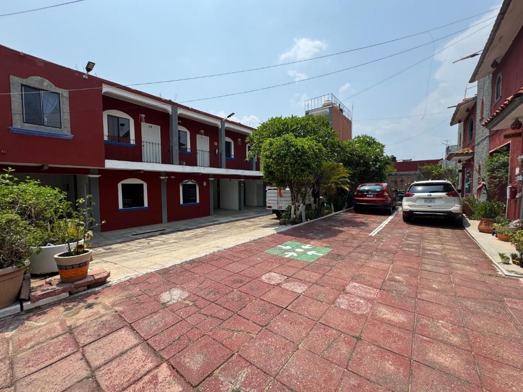 a street with cars parked in a parking lot at Hotel Casa Zoque Colonial in Tuxtla Gutiérrez