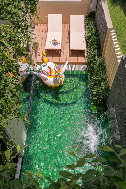 a small pool with an inflatable toy in the water at Kochi House, brand new 4BDR, 850m to the beach in Da Nang