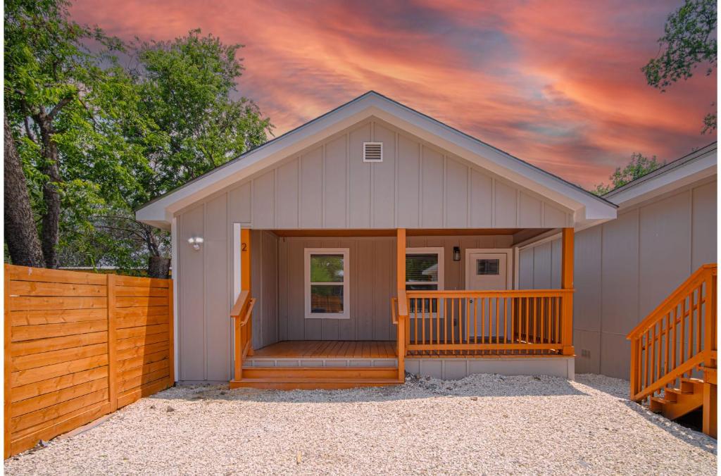 a small house with a porch and a fence at Your Amazing 3BR2BA Downtown Delight in San Antonio