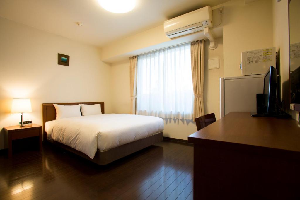 Postel nebo postele na pokoji v ubytování Hotel Hakata Place