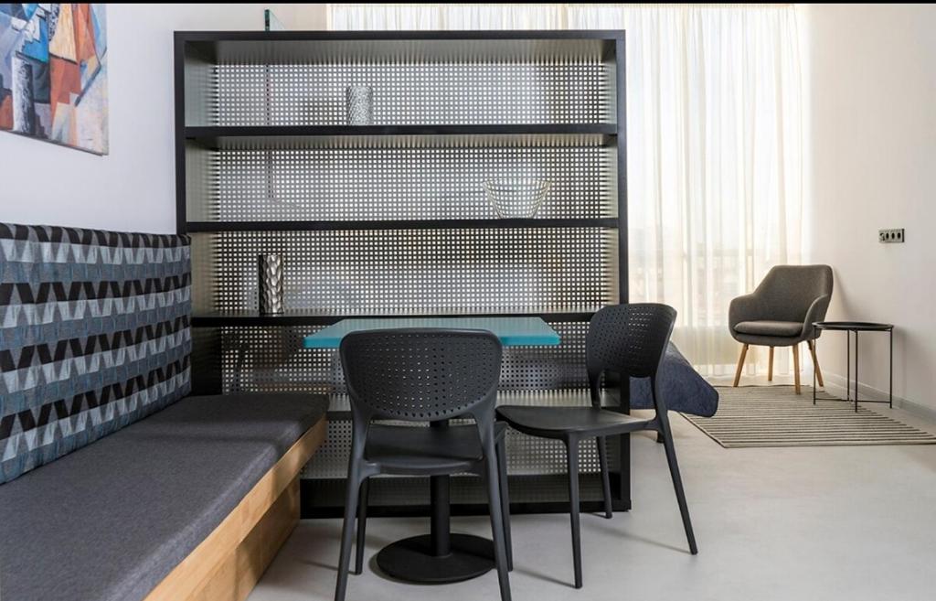 a dining room with a table and chairs at Loft студія в Аркадіі з шикарним видом города in Odesa